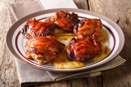BBQ Chicken Dinner. Two servings of our tender boneless skinless chicken thighs, grilled and baked. Paired with our homemade bourbon molasses baked beans