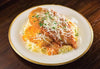 Chicken Parmesan with Pasta. Our version of the classic Italian dish is made with lightly breaded chicken breasts baked to perfection and topped with Parmesan Cheese. Served with angel hair pasta and a side of our homemade creamy tomato basil marinara sauce. Always a favorite and sure to please!