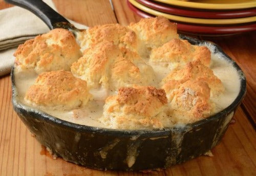 You will love our twist on chicken and dumplings.  We like our dumplings biscuit style!  Our traditional béchamel sauce is teamed with slow roasted chicken and homemade broth, celery, carrots and onions.  We top this creamy rich dumpling sauce with our garlic, cheese biscuits.  This dish is a Front Porch Pantry favorite! Moms meals, hearty cooking.