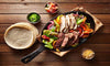 Our Sunset Serrano Chicken and Steak Fajitas are a generous portion. Marinated and grilled to perfection with savory peppers and onions, our fajitas are served with a sunset cheese queso, flour tortillas, corn tortillas and salsa. A Tex-Mex favorite for all!