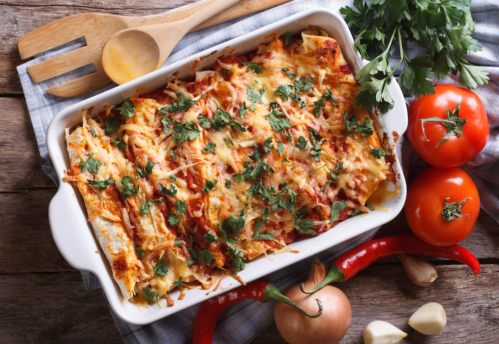 Chicken Enchiladas Verde.Our Chicken enchiladas verde are prepared with tortillas stuffed with a spicy mixture of shredded chicken, onions, tomatoes, cilantro and covered in an enchilada verde sauce and cheeses. Our verde sauce is made from roasted tomatillos, chili peppers, jalapeños, chicken broth, cilantro, parsley, onions and house seasoning.