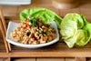 Chicken Lettuce Wraps. Our fresh lettuce wraps are a delicious combination of chopped chicken, minced sautéed garlic, onion, hoisin sauce, soy sauce, rice wine vinegar, ginger, Sriracha, water chestnuts, green onions, green leaf lettuce, house seasoning served with Pan Asian dressing on the side. Light, healthy, delicious!