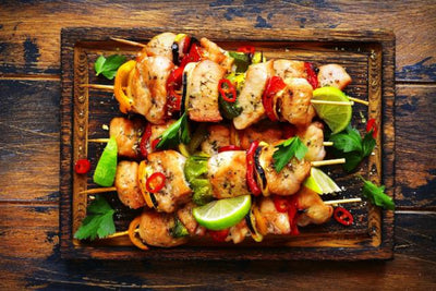 Our grilled chicken breasts bites are marinated in soy sauce, lime juice and honey and basted with a mild Sriracha sauce. Served over spinach with red peppers, zucchini and squash. Low carb, healthy, Paleo, keto, diet, friendly.