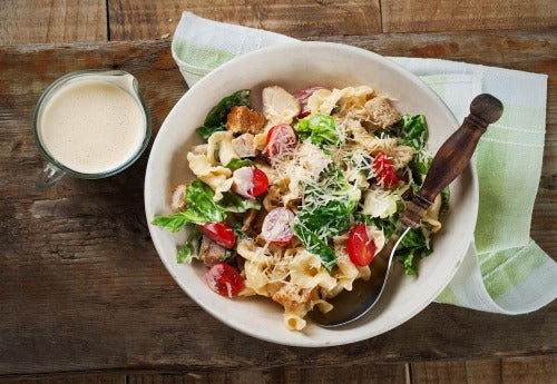 Bow Tie Chicken Pasta Salad. You will love our Festive Pasta, shaped like a ballerina's dress teamed with a handsome bowtie pasta.  We add tender grilled chicken mixed with Basil Pesto, Homemade Mayonnaise, Spinach and Fire Roasted Red tomatoes, Sweet Cherry tomatoes, Fresh lemon juice topped with freshly grated parmesan and basil.
