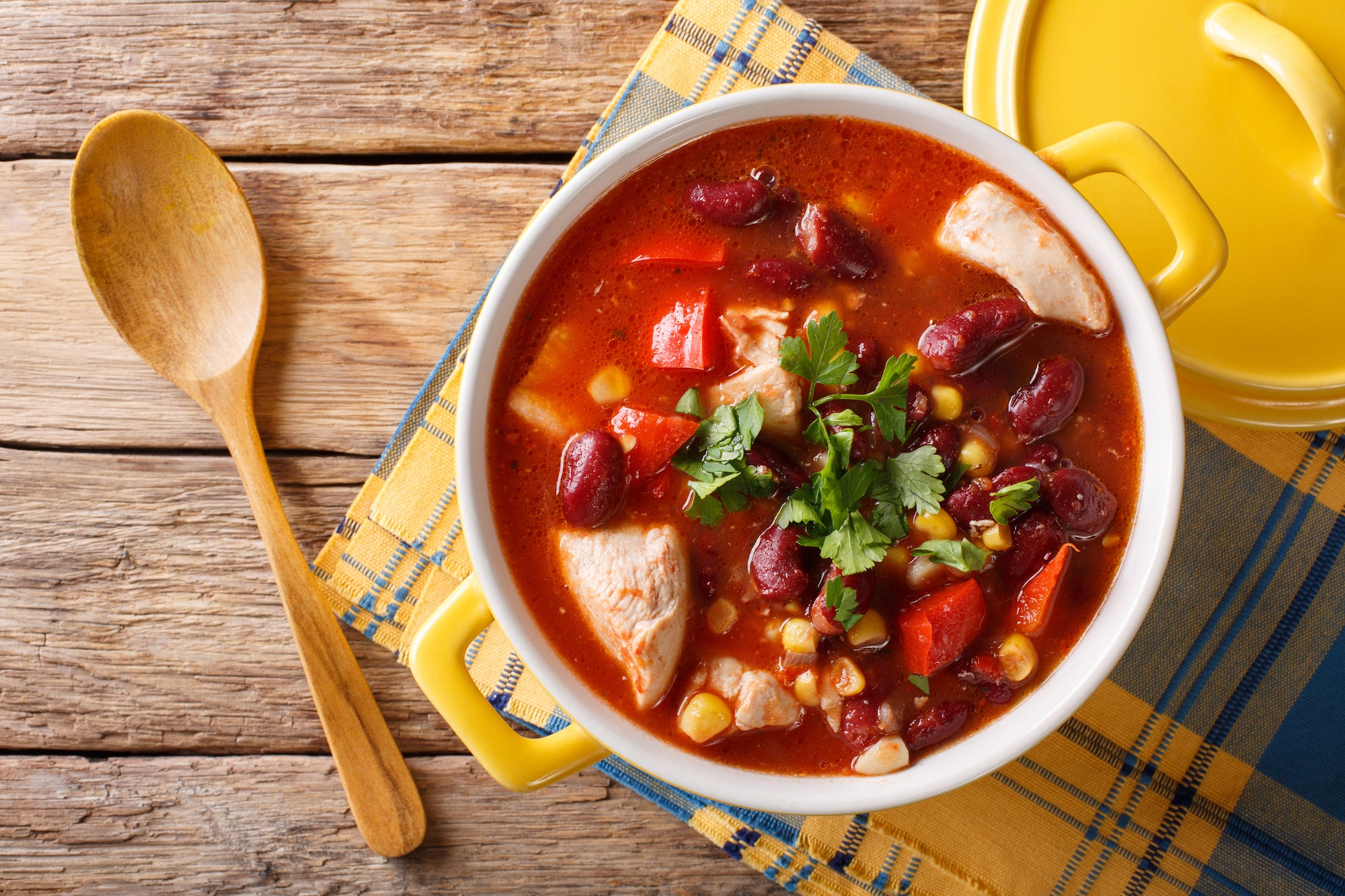 Chili Chicken - Low Carb. You will love our hearty chicken and red bean chili. Our chicken is simmered with garlic, onions, peppers, house seasonings with roasted chicken and topped with fresh and fragrant chopped parsley and green onions. Perfect for a starter, lunch or add a salad and you are set for dinner. Served with cheese and sour cream