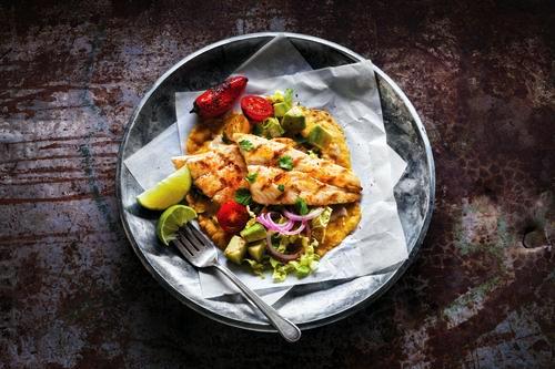 Fish Tacos with Salsa. You will love our broiled light and flaky tilapia sautéed in a mélange of onions, peppers, shredded carrots, cabbage, cilantro, and garlic, topped with Monterey Jack cheese. Served with a flavorful tomatillo salsa, red salsa, corn tortillas, and Mexican Rice!