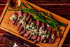 Our juicy skirt steak is bursting with juicy rich flavor. Marinated overnight for outstanding flavor with exceptional marbling and tenderness.  Our skirt steak is served rare with herb butter and roasted asparagus. Low carb, paleo and keto friendly meal.