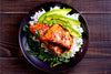 Honey Glazed Salmon. Our organic salmon is grilled and basted with a honey teriyaki glaze, served over spinach and rice topped with an avocado aioli. Low carb, low sodium, Paleo, Keto, and diet friendly.