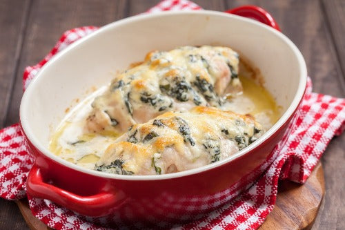 Cheesy Pesto Chicken, Zoodles and Spinach - Low Carb. Our tender grilled chicken is seasoned with spices and sliced. We top with white wine sauce and Italian cheeses. This is a fantastic recipe that is low in calories and low in sodium, served over power greens and zoodles.