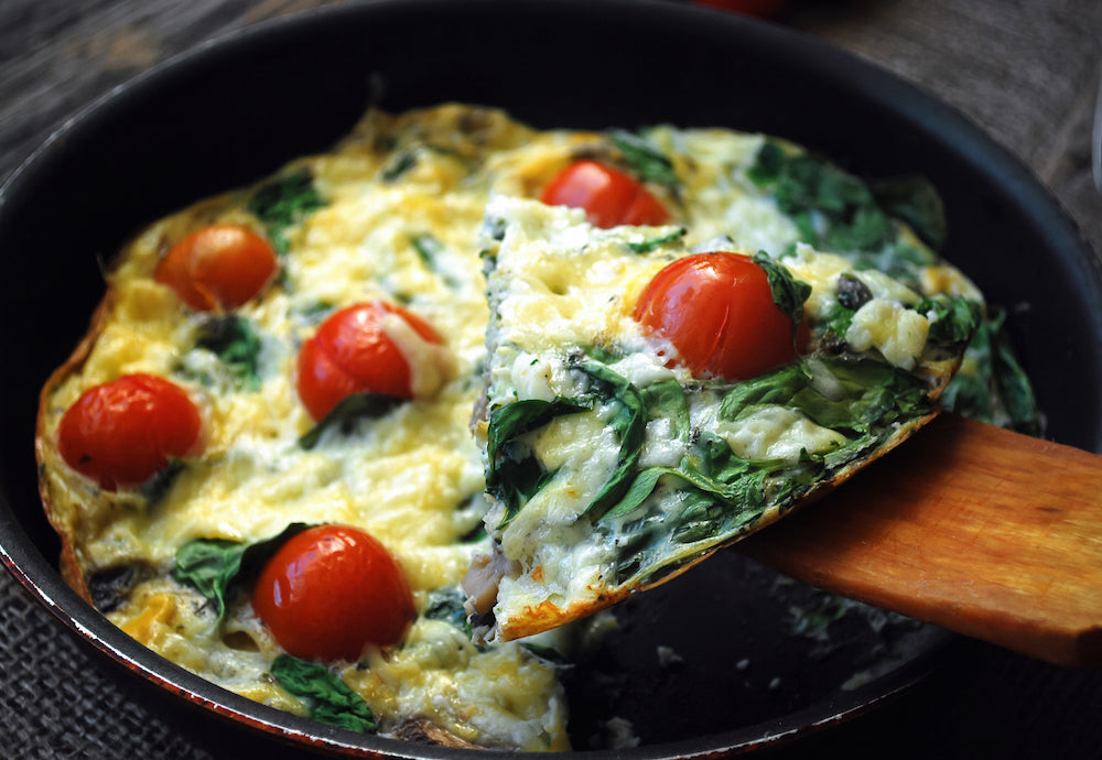 Breakfast Casserole, Spinach Frittata. Our homemade frittata, the classic Italian omelette, is made with farm raised eggs, sautéed spinach, sun-dried tomatoes, sweet cherry tomatoes, pine nuts and blended with cream and goat cheese.