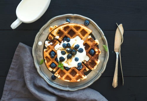 Breakfast Belgium Waffle with Whipped Cream, Blueberries and Maple Syrup